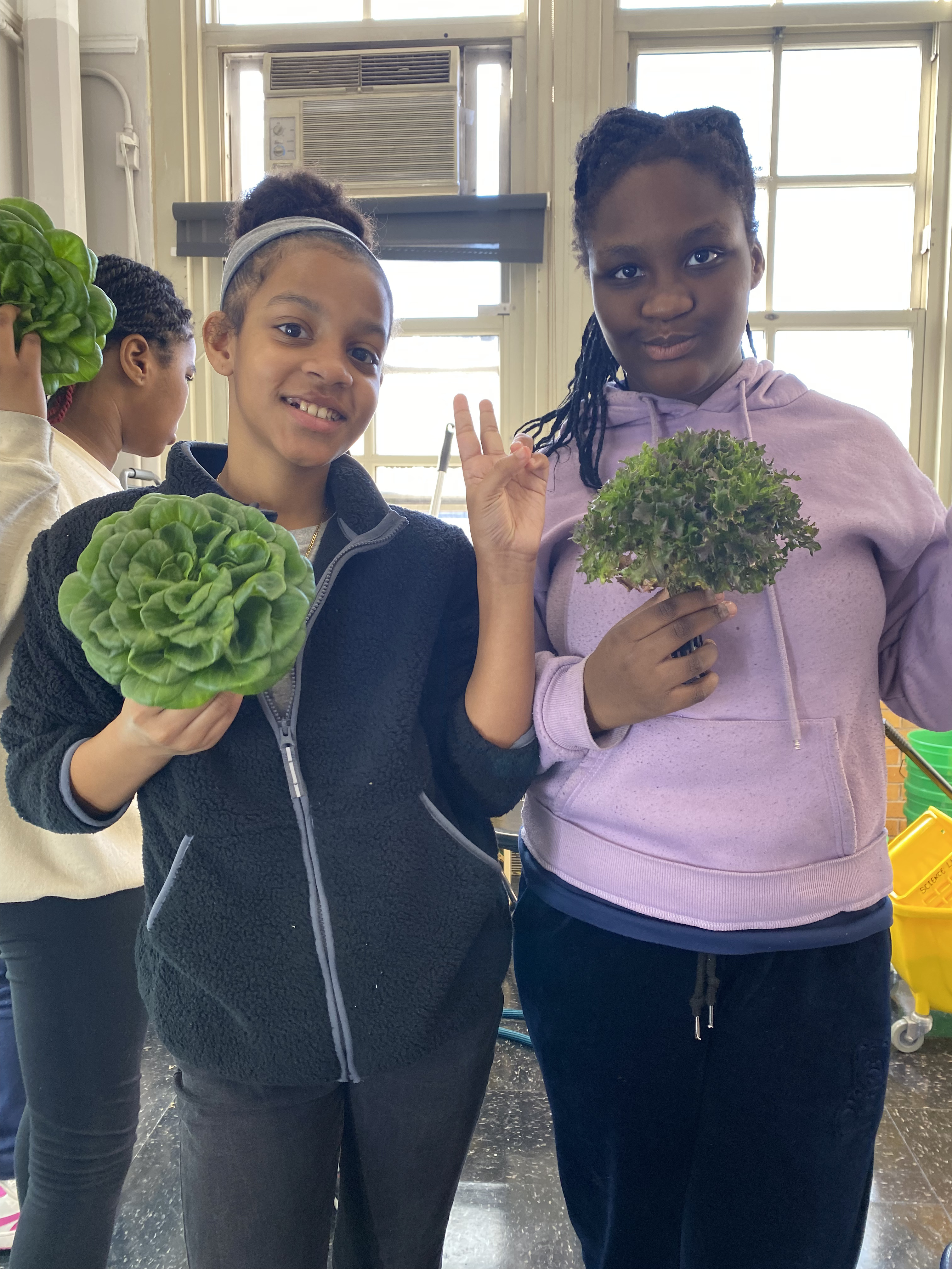 Five children standing on a polished gym floor 