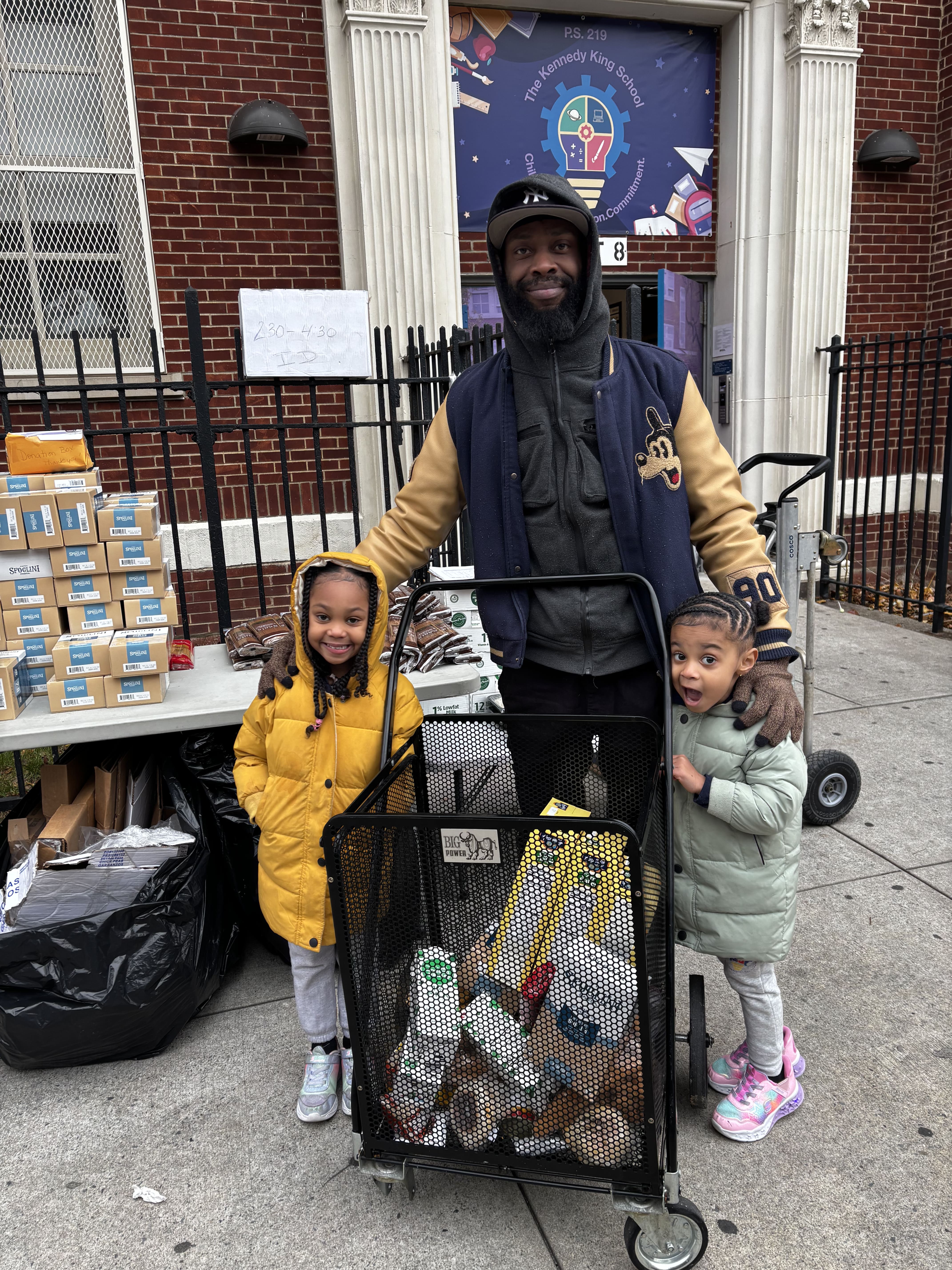 Five children standing on a polished gym floor 