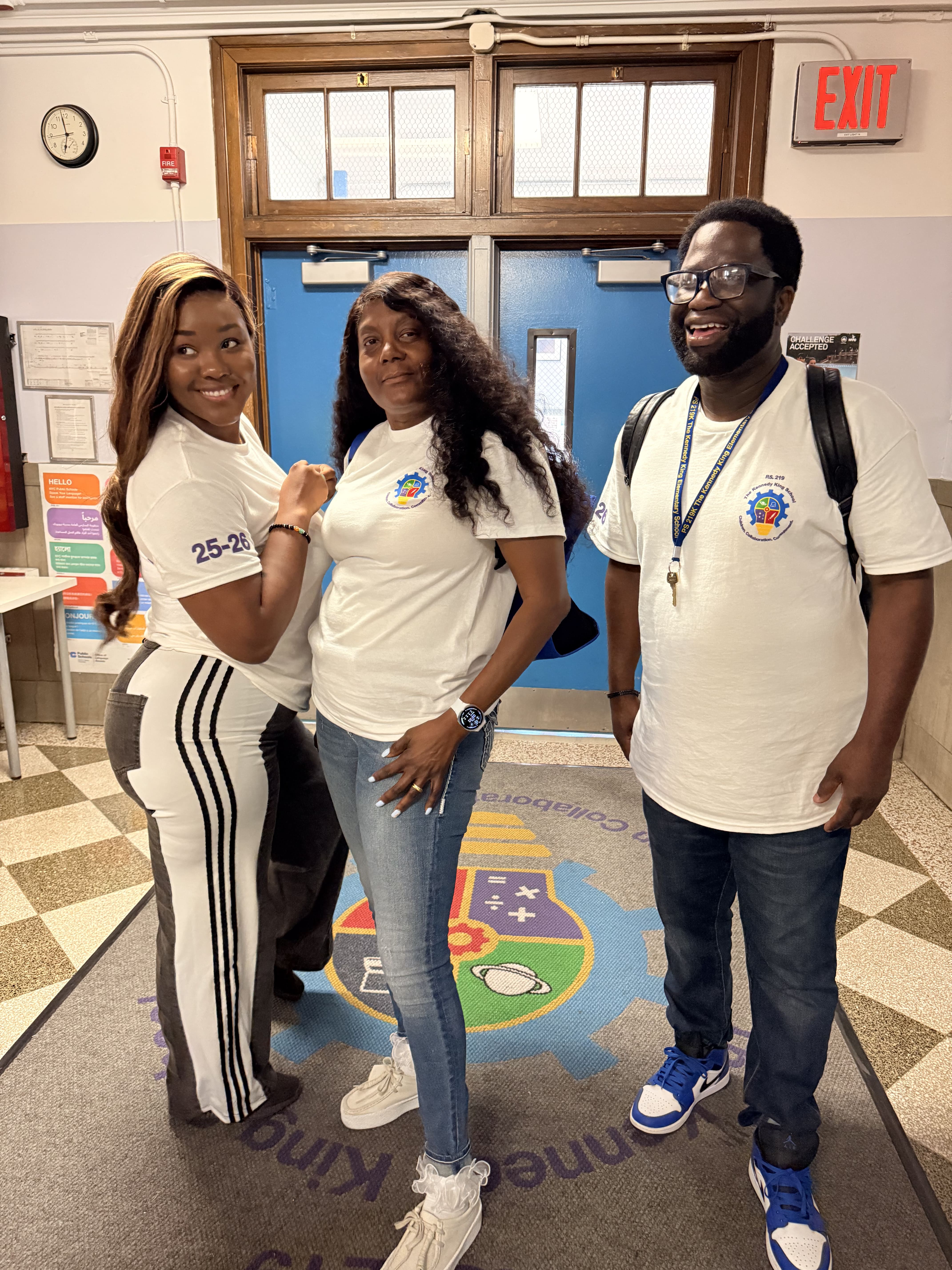 Five children standing on a polished gym floor 