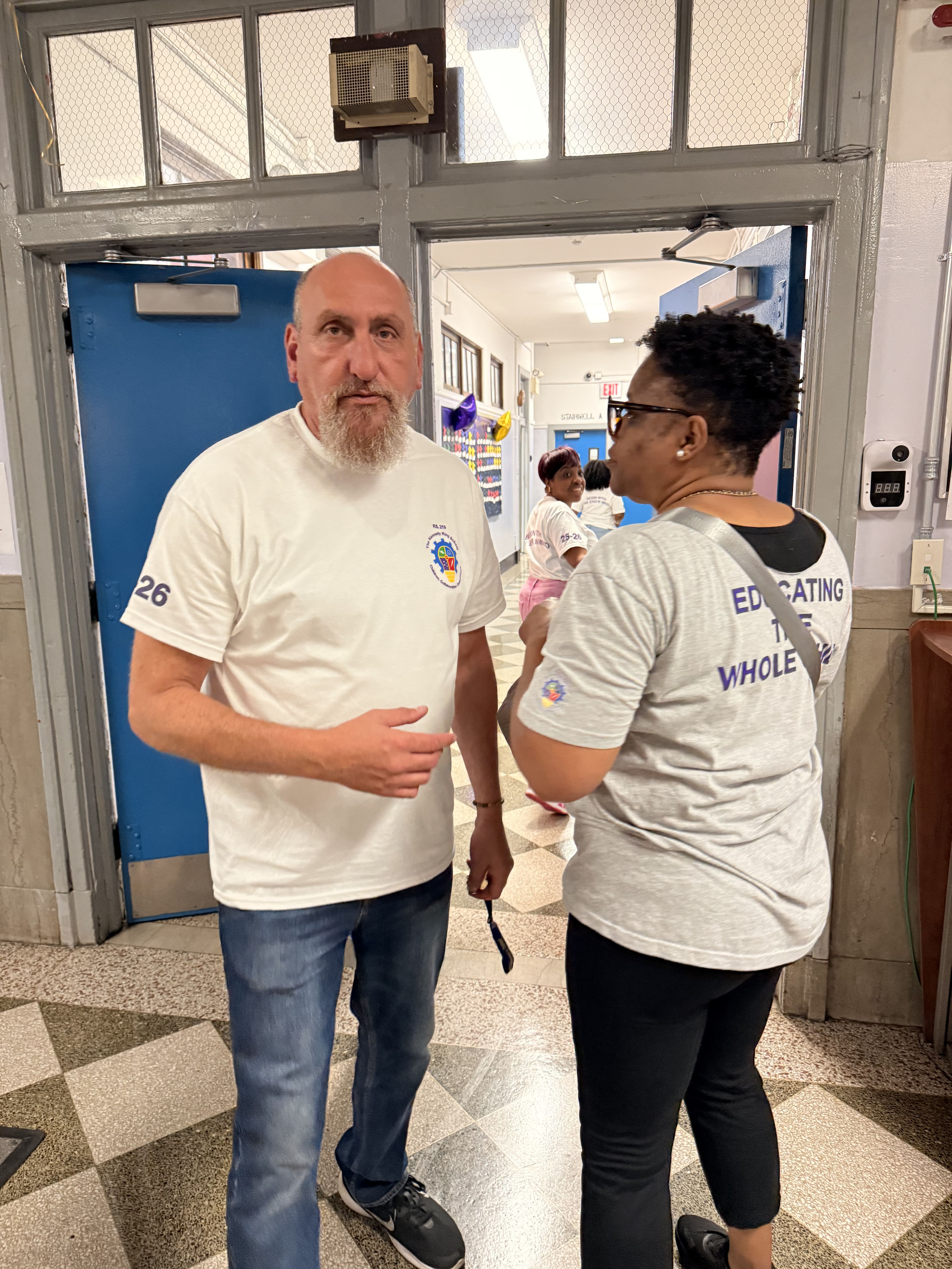 Five children standing on a polished gym floor 