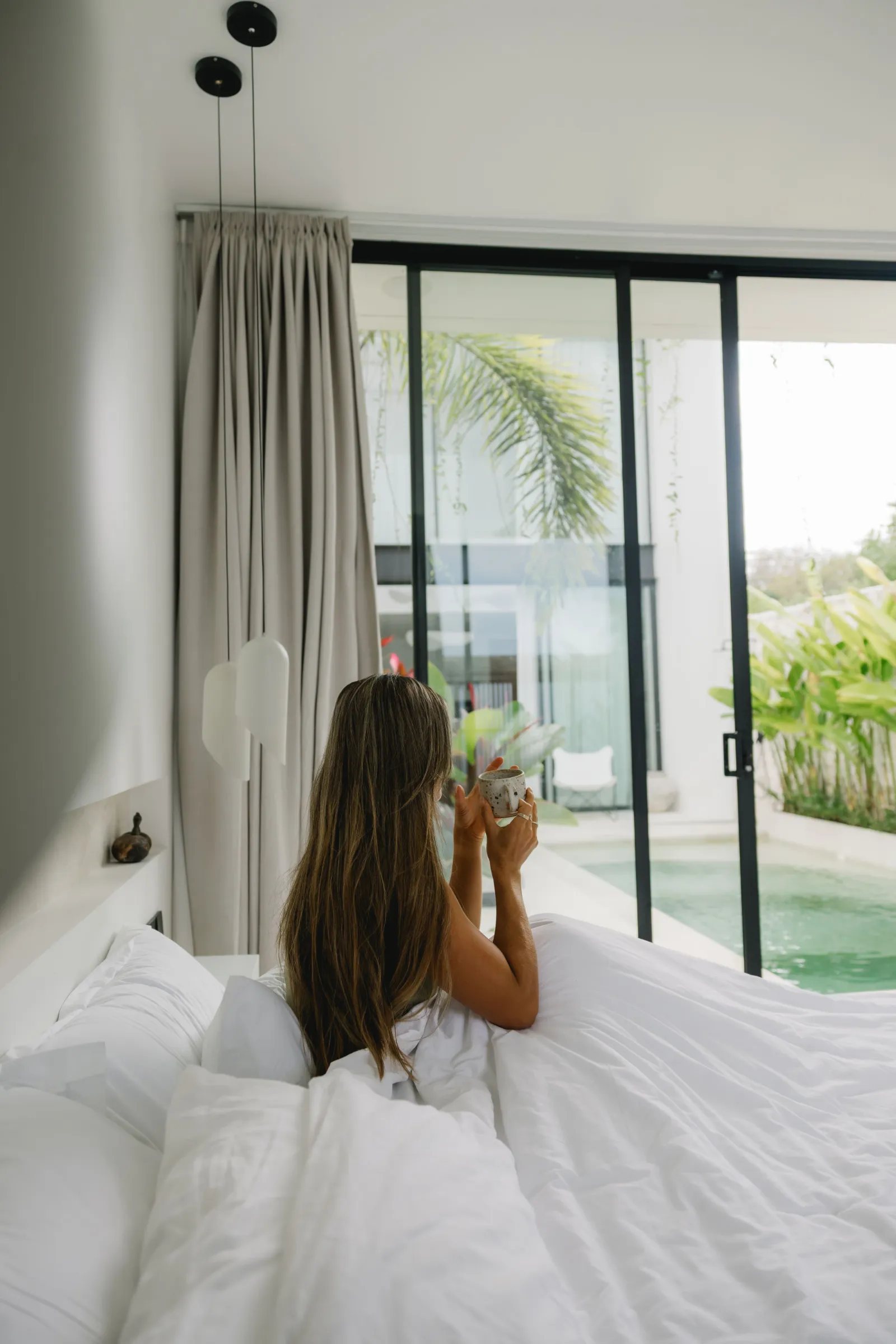 A content creator shooting beside the private pool of a two-bedroom Uluwatu villa