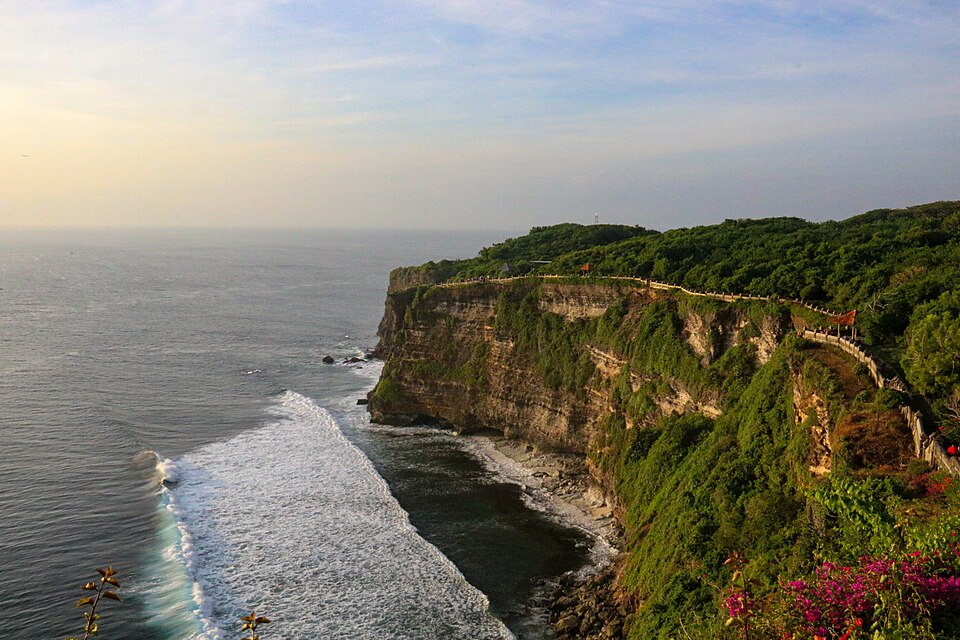 Swell breaking along the reef below the Uluwatu cliffs