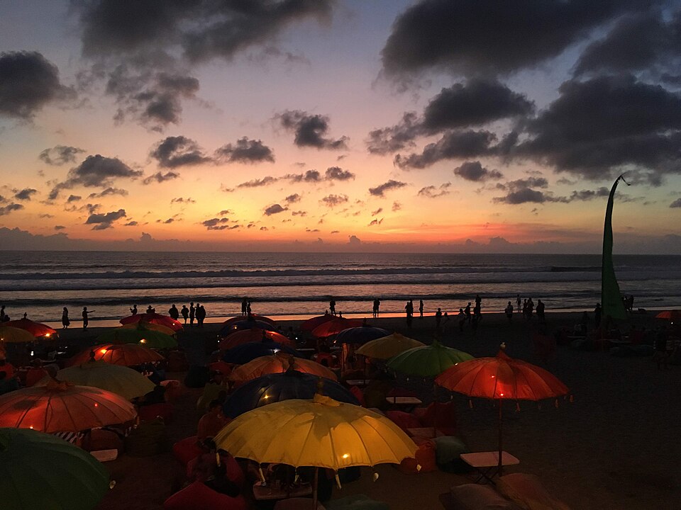 Beanbags and umbrellas on Seminyak Beach at sunset