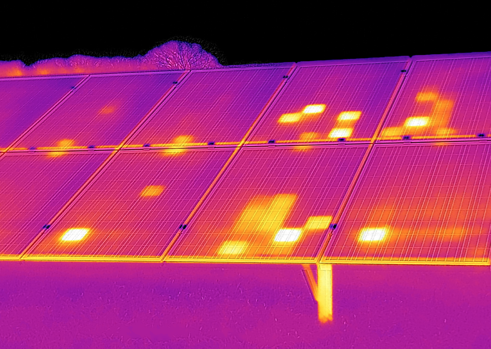 Thermal scan showing solar panels with multiple hot spots in yellow and white on a purple background.
