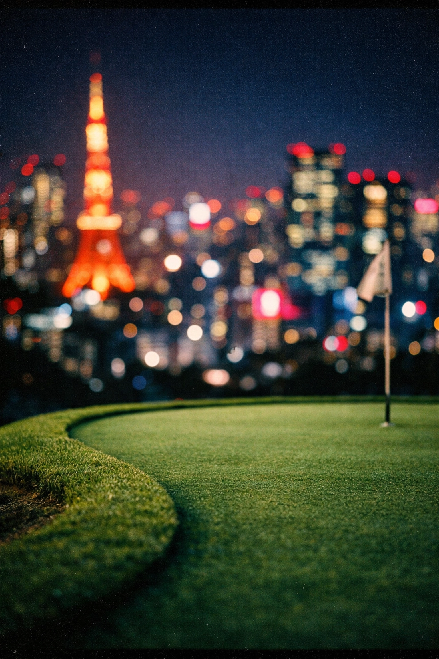A pristine golf putting green in the foreground with the vibrant neon Tokyo city skyline at night.