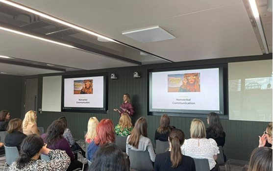 Workshop on communication and negotiation skills with audience attending a professional presentation