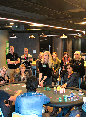 Participants learning through a guided poker workshop focused on practical skills