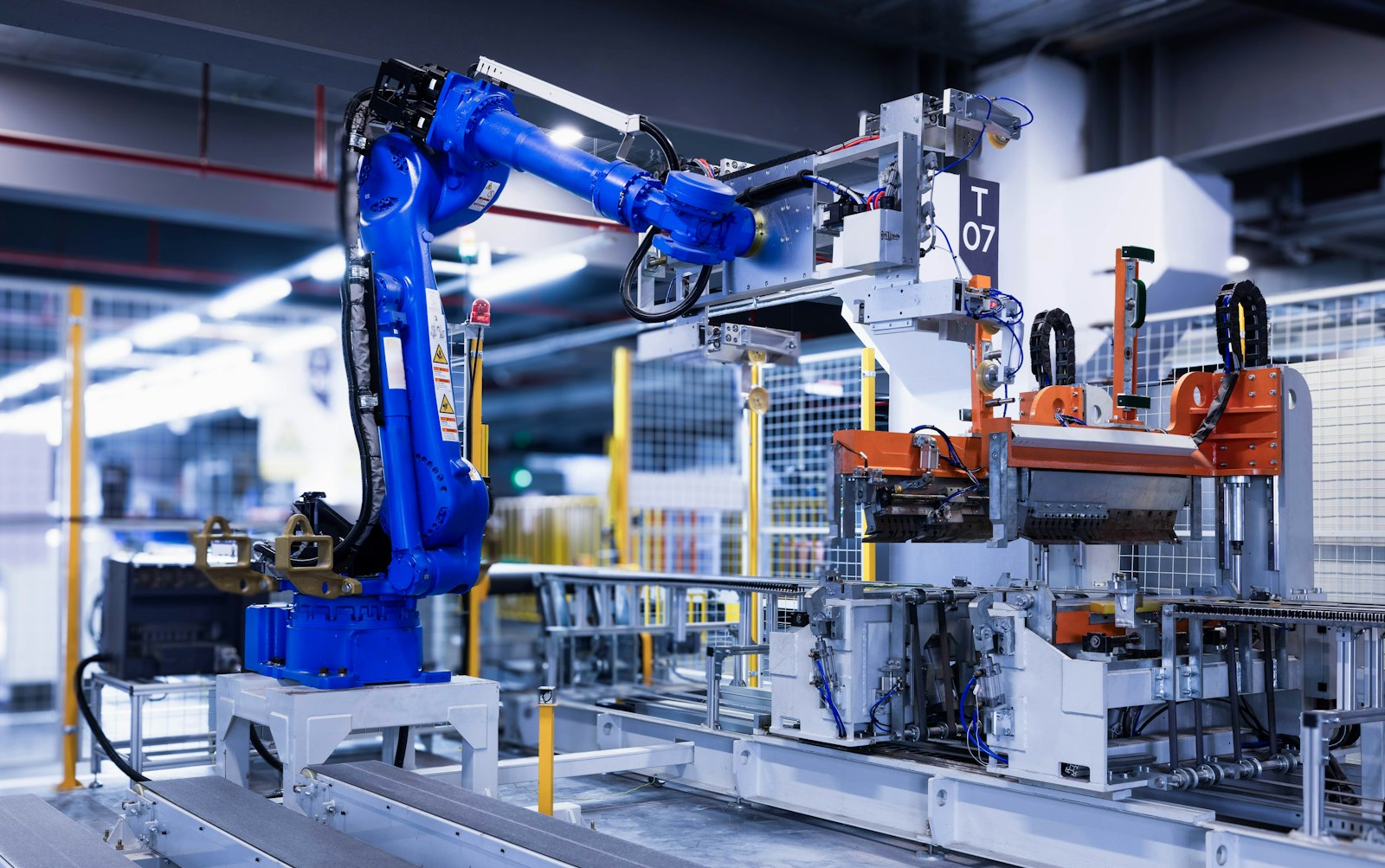 Industrial robotic arm actively working on a component in an advanced manufacturing facility