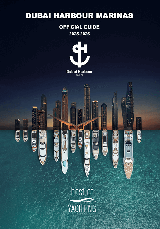 Aerial view of Dubai Harbour Marinas showing yachts docked in water with a city skyline at dusk, text reading 'Dubai Harbour Marinas Official Guide 2025-2026' and 'best of yachting.'