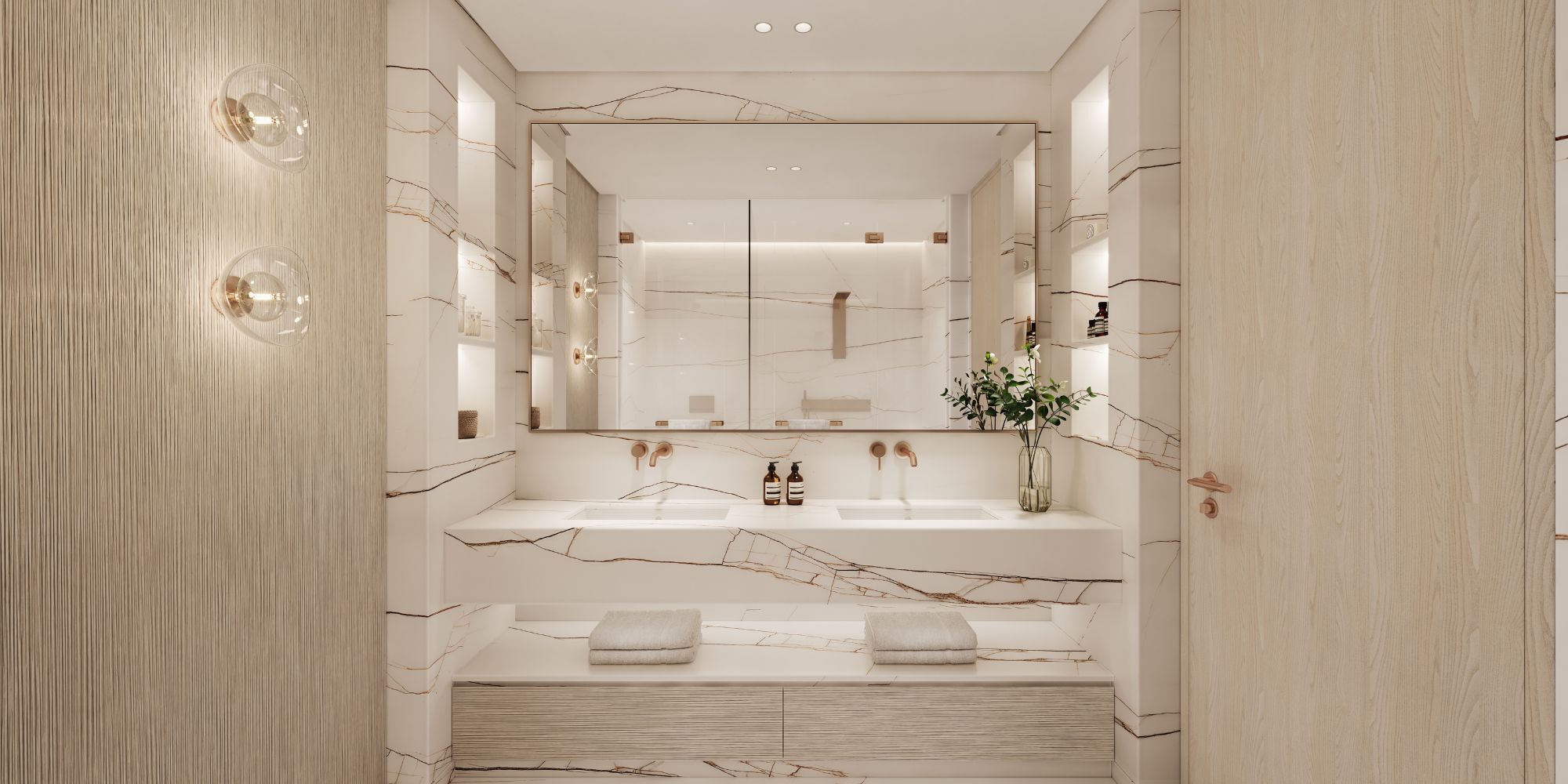 Modern bathroom with double sink, large mirror, marble surfaces, wall lights, and wooden door.