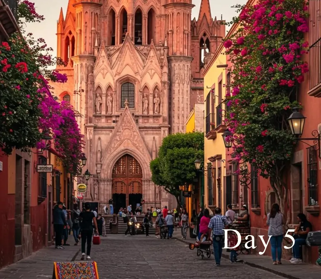 Cobblestone street in a colorful town with people walking towards a large ornate stone church with statues and stained glass windows at sunset.