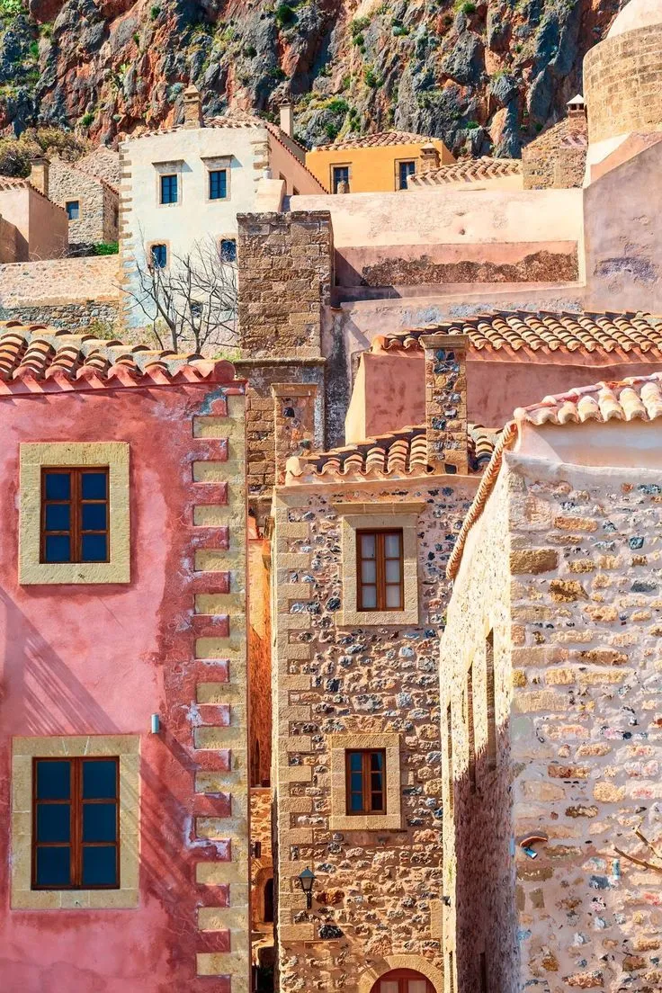 Colorful hilltop village with terracotta rooftops and winding stone steps in the Mediterranean
