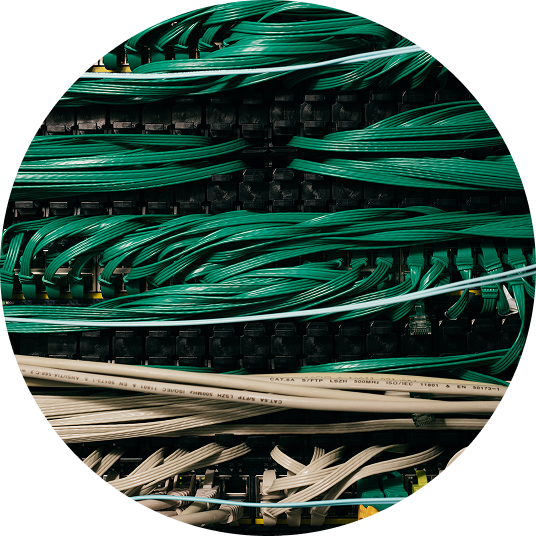 Close-up of organized green and beige network cables connected to a server or switch panel.