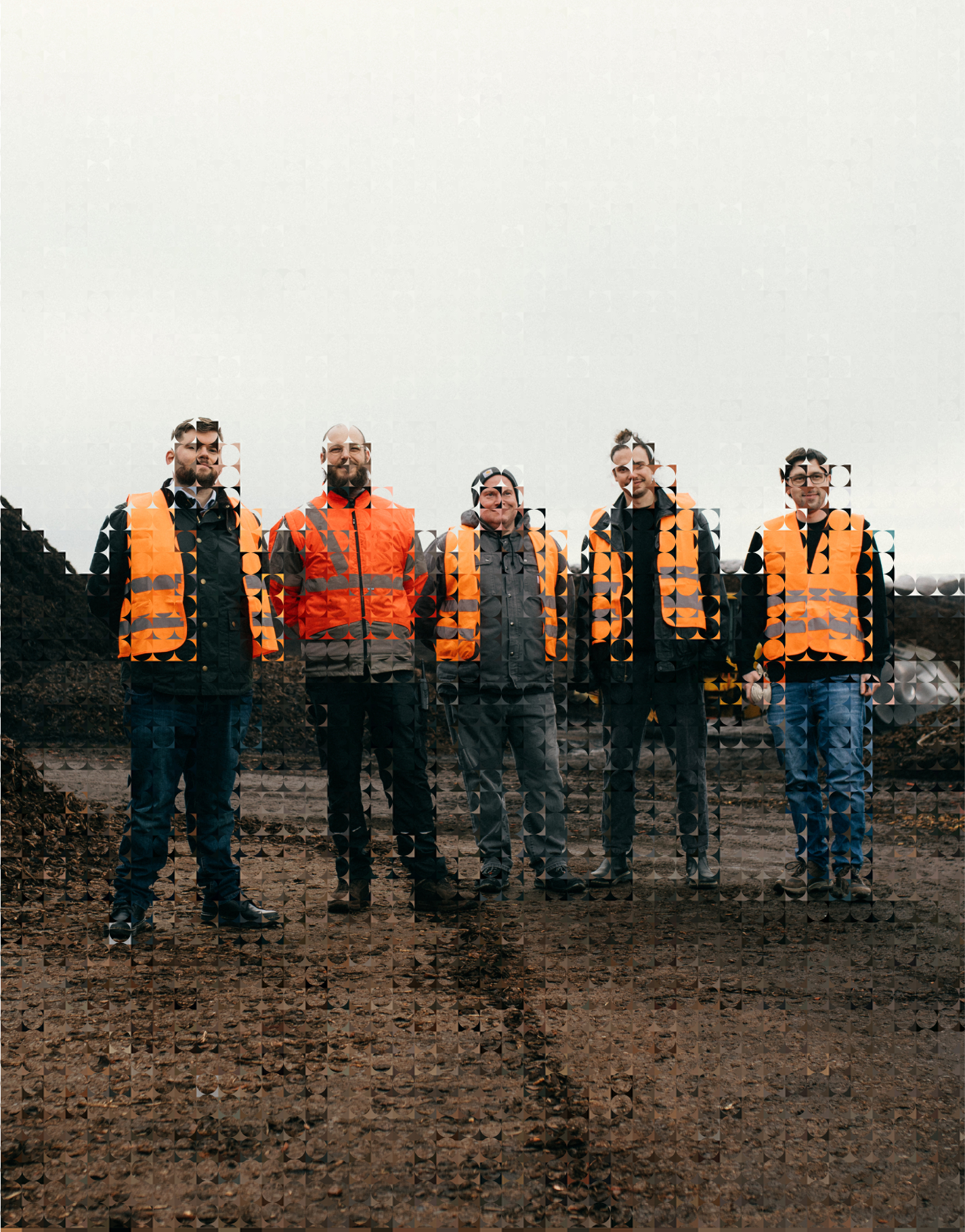 Five people standing outdoors wearing high-visibility orange safety vests on a cloudy day.