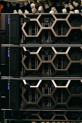 Close-up of stacked server racks with hexagonal ventilation patterns in a data center.