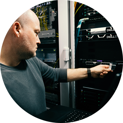 Close-up of server racks with hexagonal metal grills and visible network hardware inside.