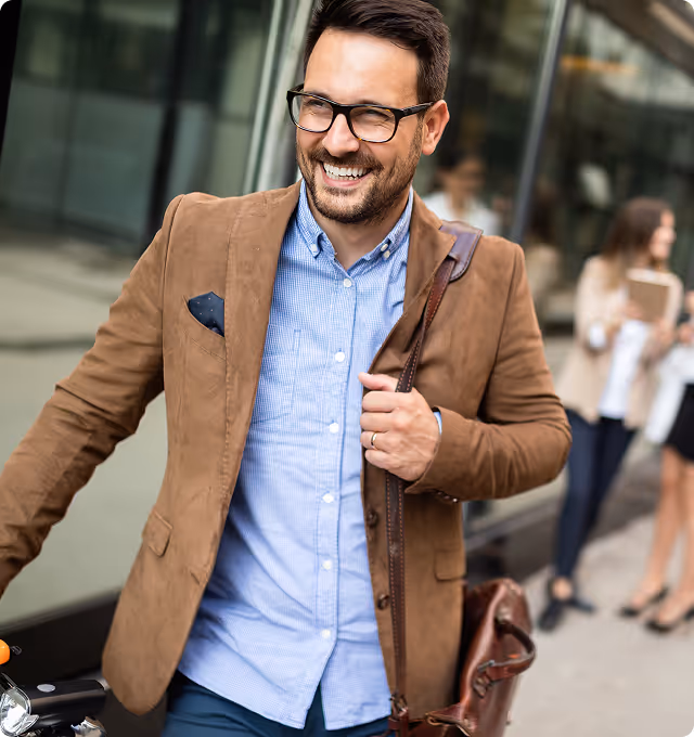 A modern, professional entrepreneur smiling, symbolizing the success of a ONE Power Fitness studio owner.