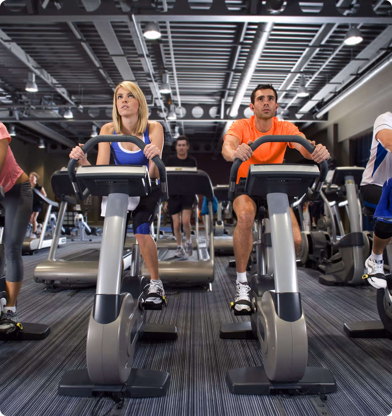 Members training on high-end cardio equipment in a digitally optimized gym environment.