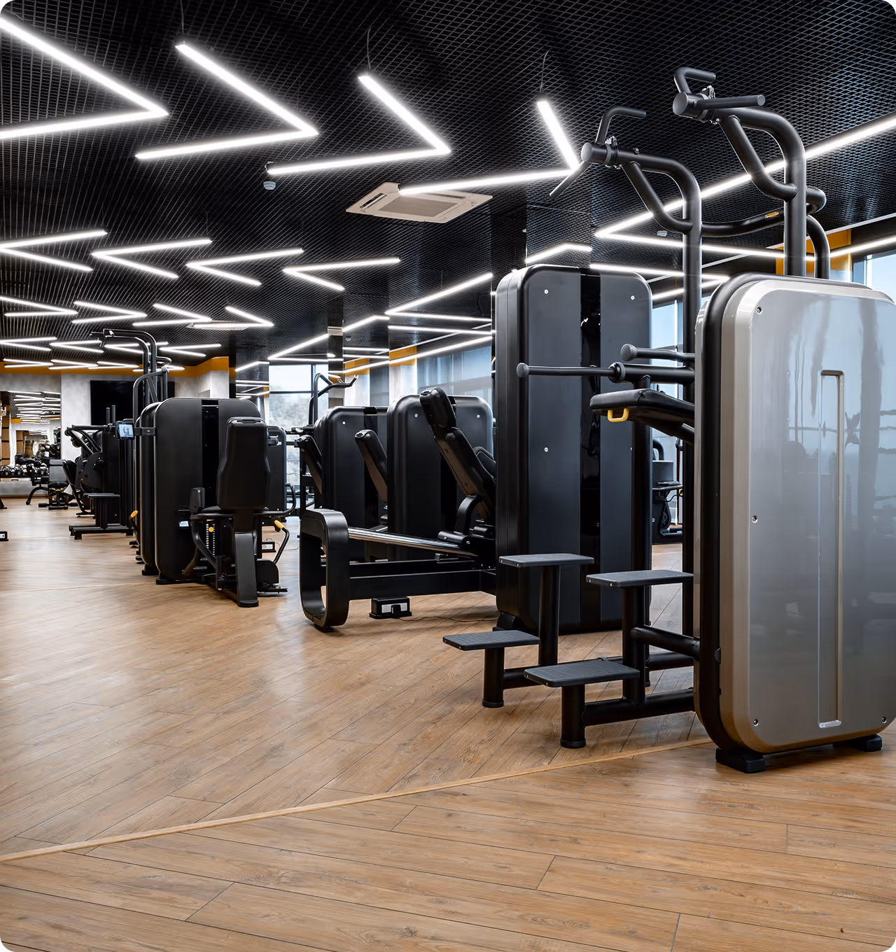 Sleek, modern strength training area with high-tech equipment and industrial design aesthetics.
