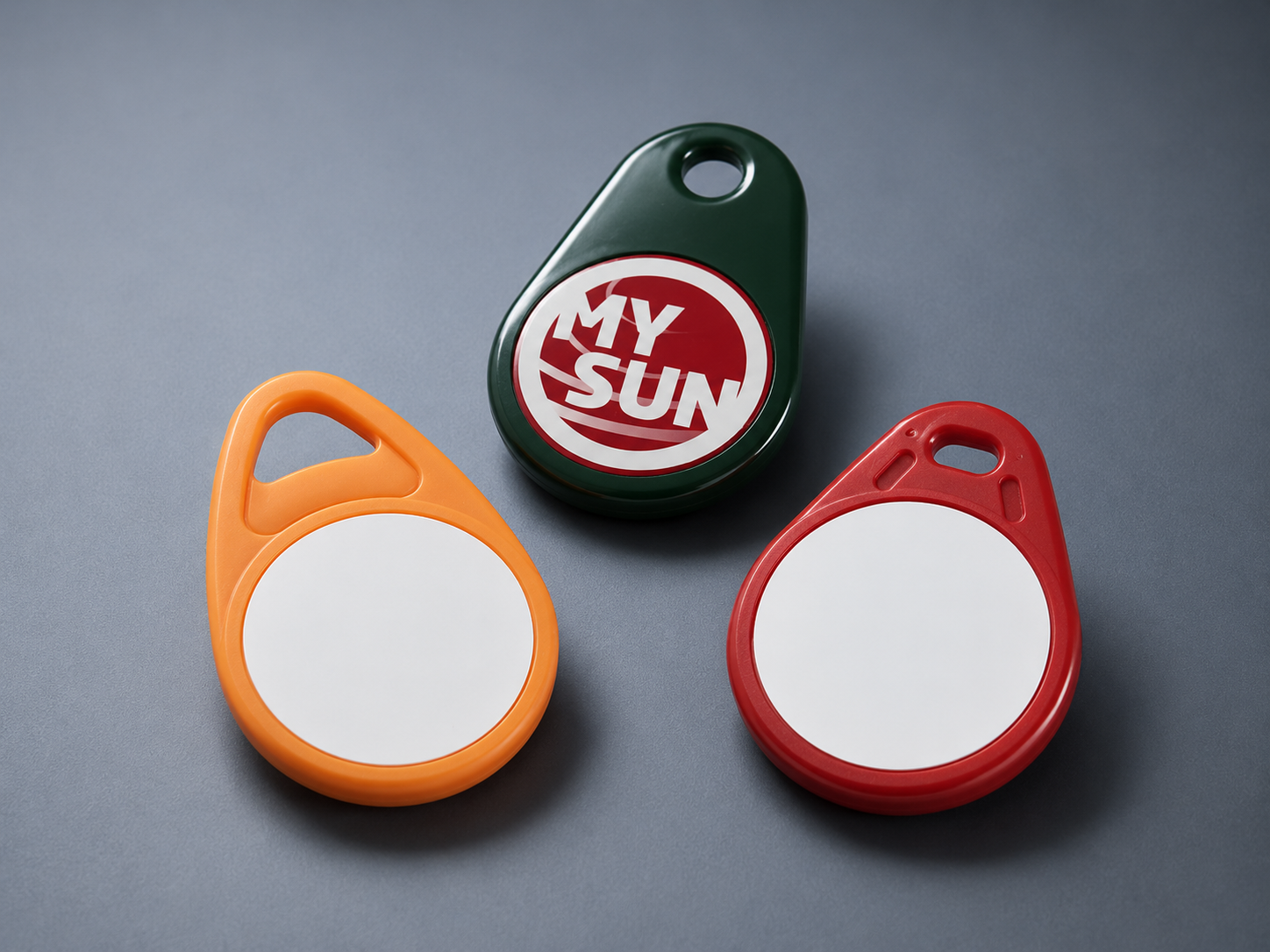 Drei bunte Schlüsselanhänger, einer grün mit 'MY SUN'-Aufdruck, zwei ohne Beschriftung.