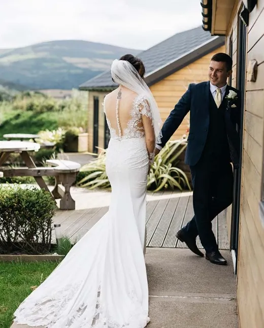 Outdoor wedding ceremony at Sunset Lakes with hay bale seating