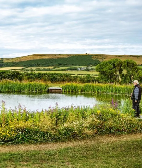 Tranquil coarse fishing lake at Sunset Lakes with wooded banks