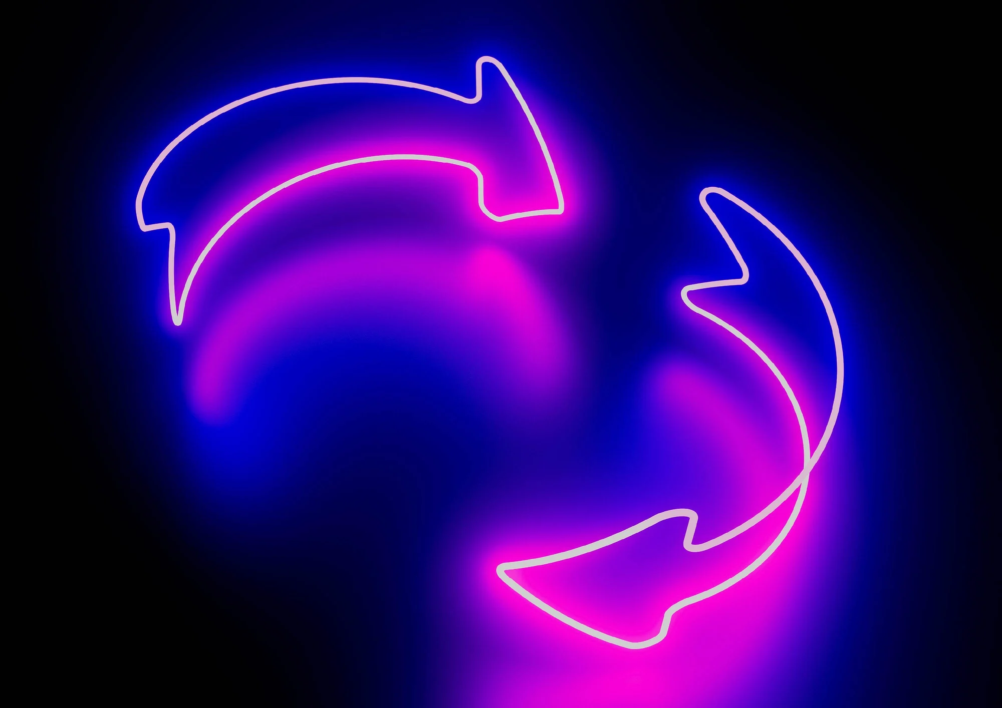 Two neon arrows glowing in pink and purple forming a circular motion on a dark background.