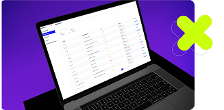 Laptop displaying a web application with a data table and a large green X icon on a purple background.