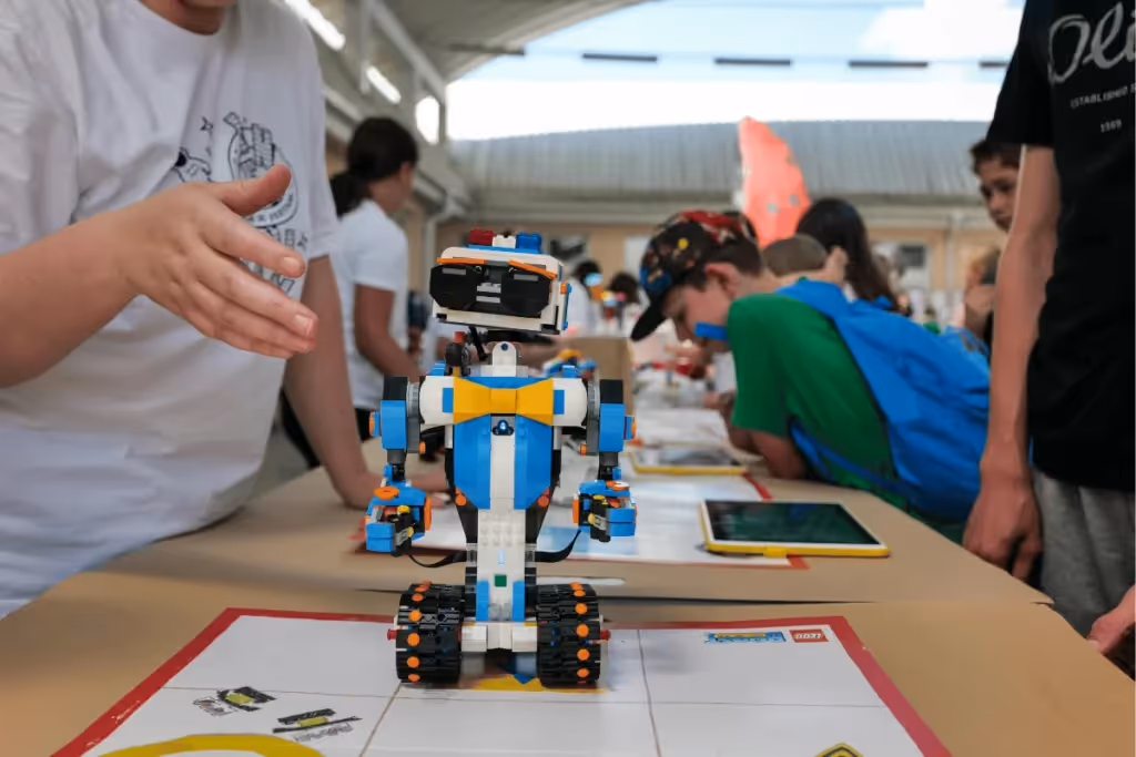 Kids participating in a robotics fair with a robot on display.