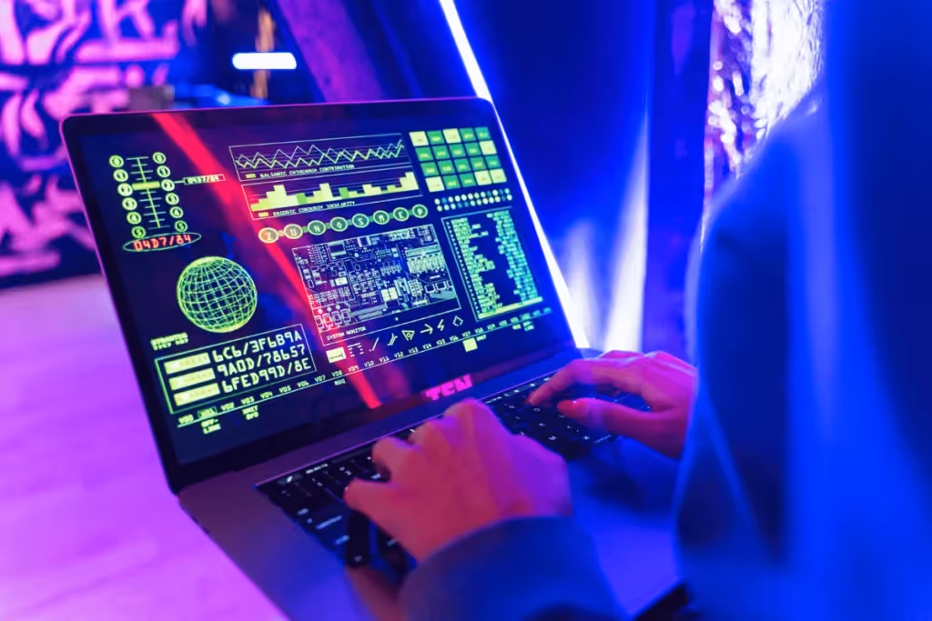 User interacting with digital data analytics on a laptop screen in a neon blue environment.