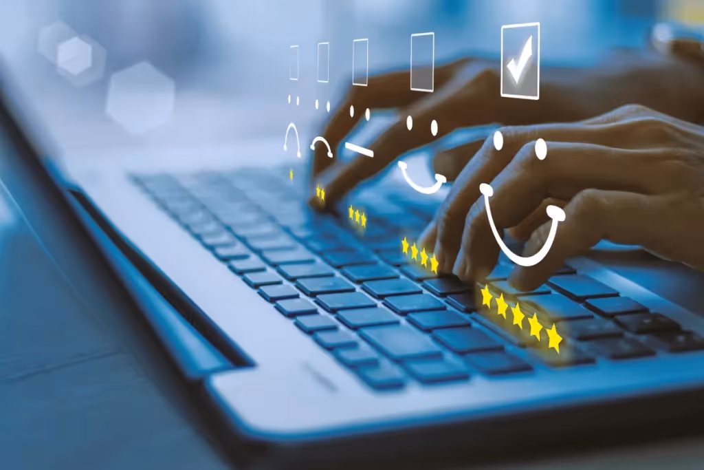 User interacting with a satisfaction rating system, represented by emojis and stars on a laptop.