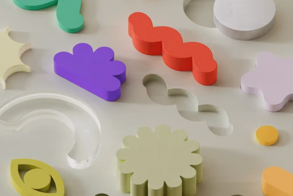 Creative arrangement of vibrant shapes on a neutral background, showcasing abstract art.