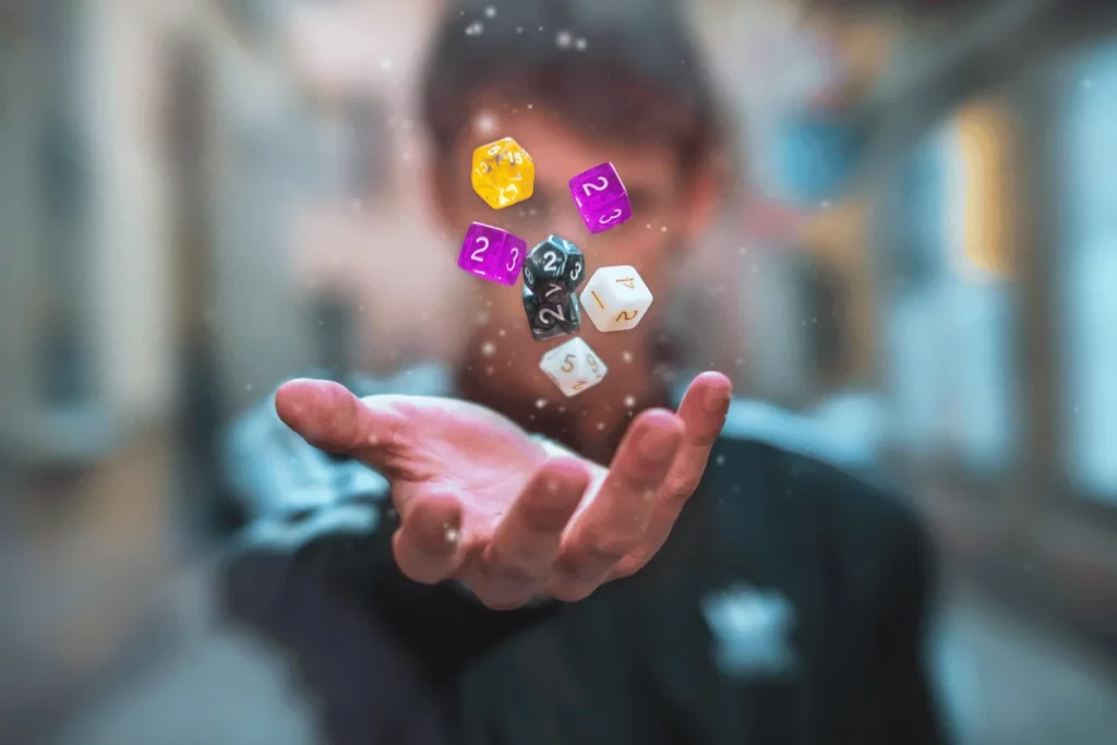Person in a blurred hallway extending an open hand with a dice floating above it.
