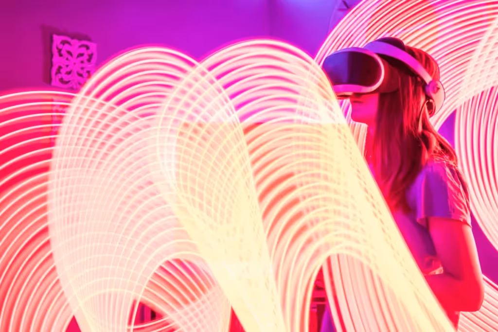Woman in VR headset surrounded by dynamic light trails in a purple-hued room.