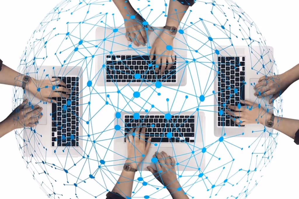 Digital networking concept with multiple hands typing on laptops connected by blue network lines.