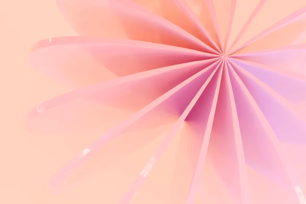 Abstract 3D rendering of pink fan-like geometric structures.