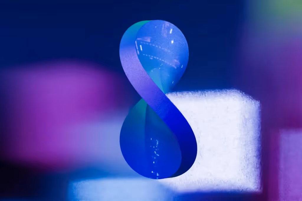A glowing abstract number 8 figure, with colorful gradients in blue and purple against a dark background.