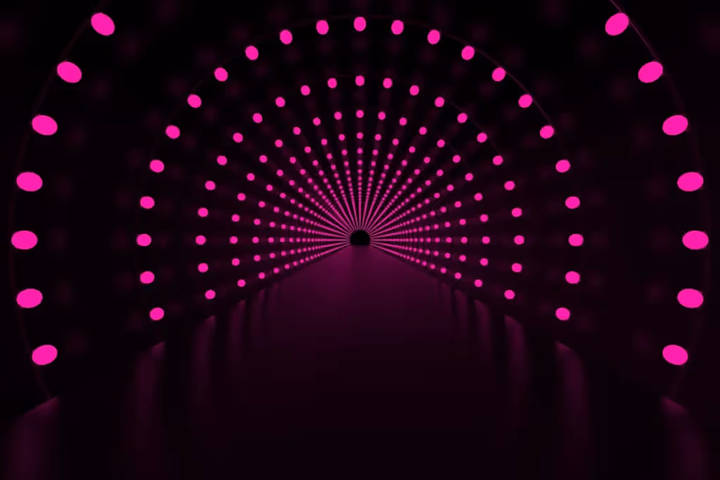 Abstract tunnel of glowing pink circles, spiraling inward to a center point against a dark environment.