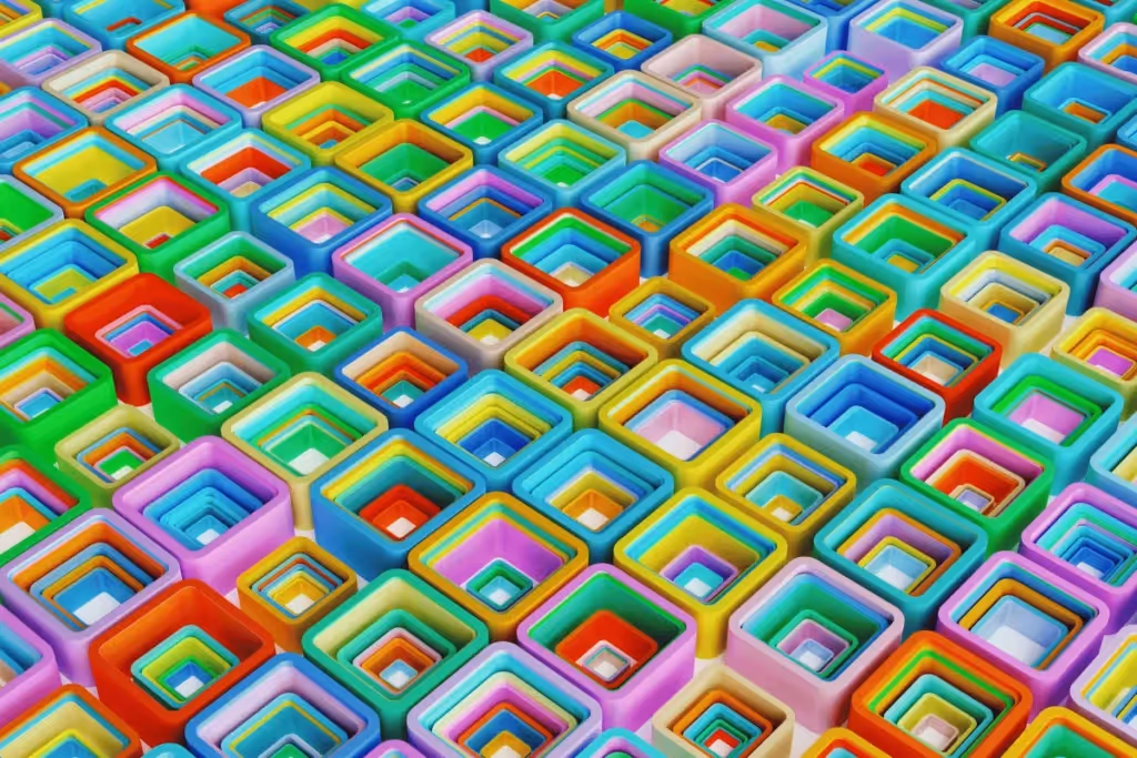 A close-up view of colorful, overlapping square shapes arranged in a grid, showcasing a spectrum of hues.