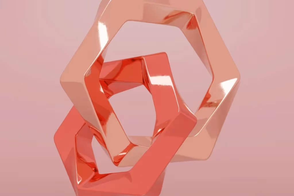 Close-up of overlapping 3D polygons with glossy red and pink surfaces