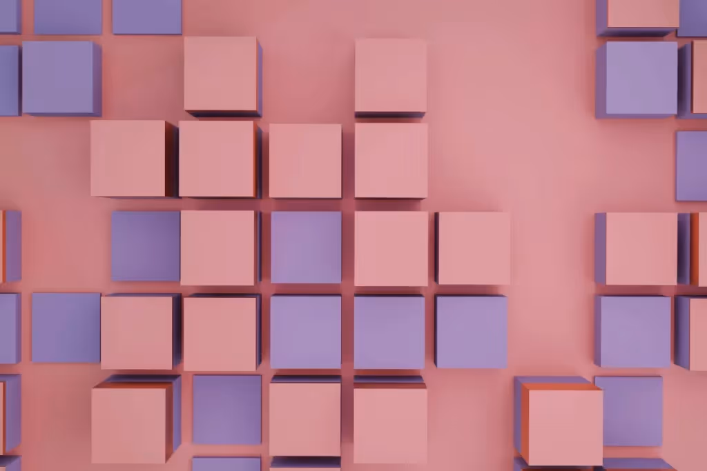 Grid of pink and purple cubes arranged on a soft pink background.