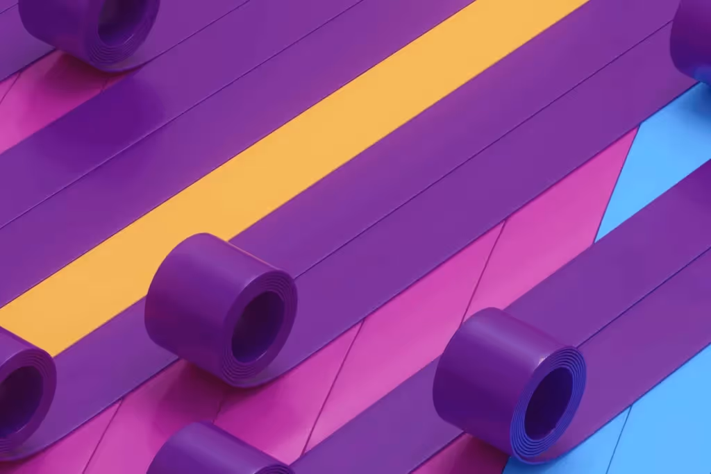 Rolls of vibrant purple ribbon arranged diagonally on colorful background.