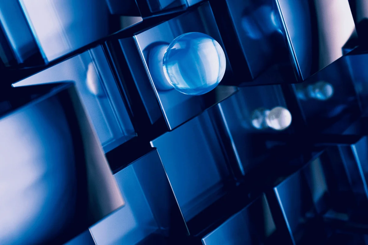 Abstract image of translucent blue cubes with reflective surfaces, featuring spheres protruding from the center, creating a futuristic, geometric design.