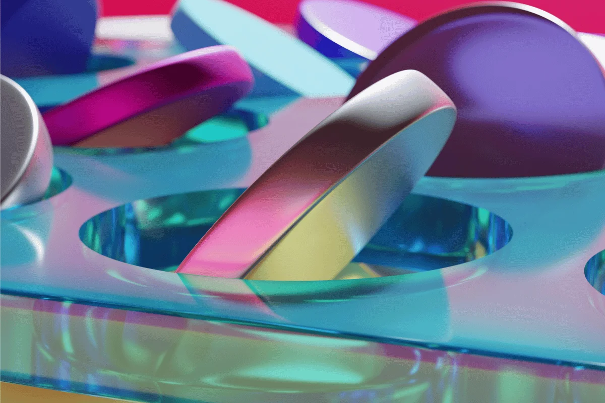 Colorful abstract scene of glossy, rounded shapes in vivid pinks, blues, and purples, placed on a translucent turquoise surface.