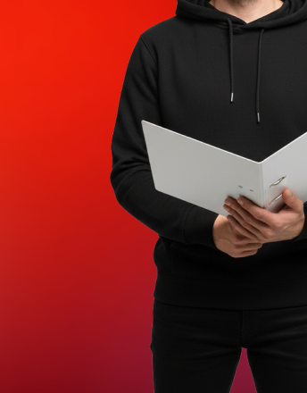 Person in black hoodie holding an open white binder against a red gradient background.