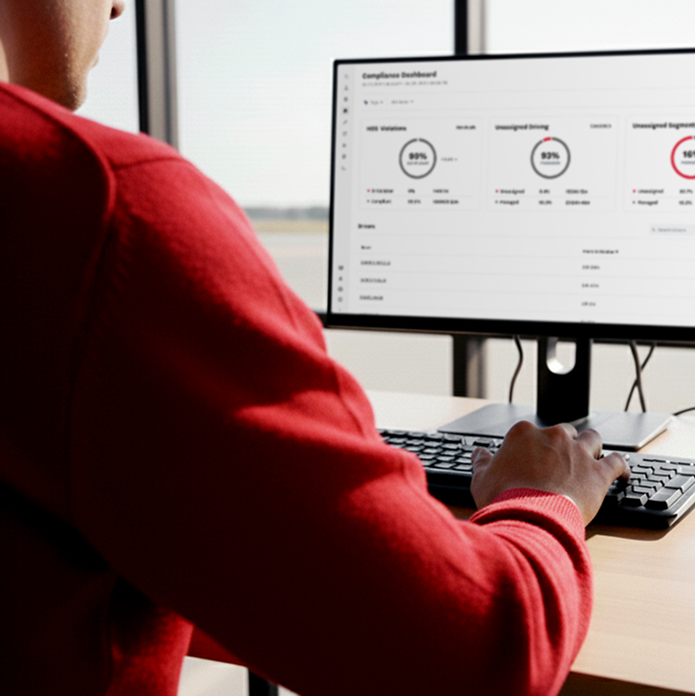 Electric vehicle charging plug connected to an orange car with a yellow charging cable.