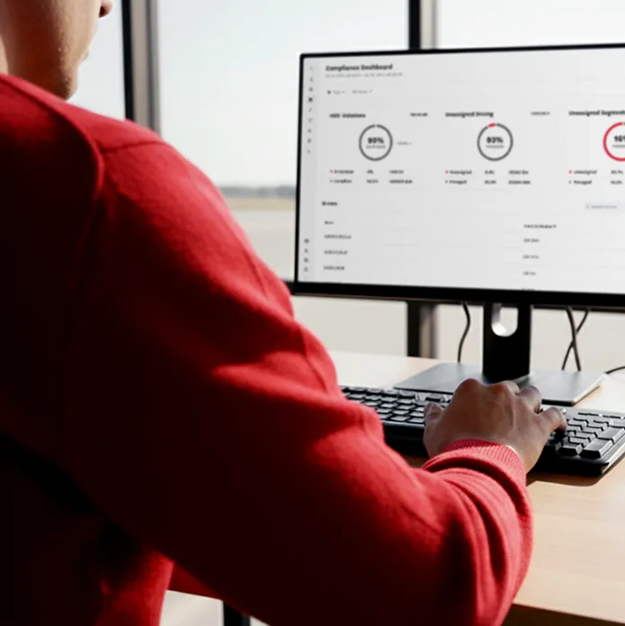 Electric vehicle charging plug connected to an orange car with a yellow charging cable.
