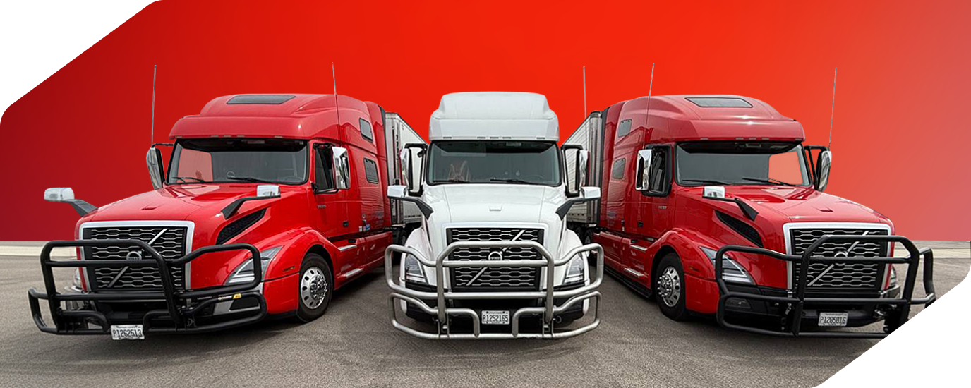 Three Volvo semi trucks, two red and one white in the center, parked side by side on a paved surface with a gradient red background.