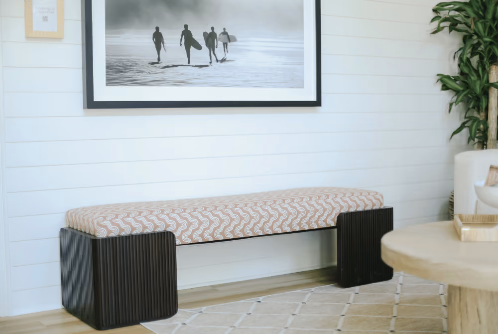 Bench and surf print hanging on wall in Journey Pediatrics peaceful waiting room.