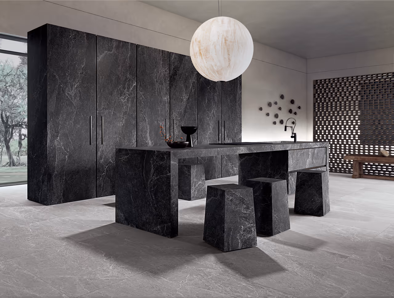 Nowoczesna kuchnia z czarnym marmurowym stołem, trzema marmurowymi stołkami i dużą kulistą lampą wiszącą.